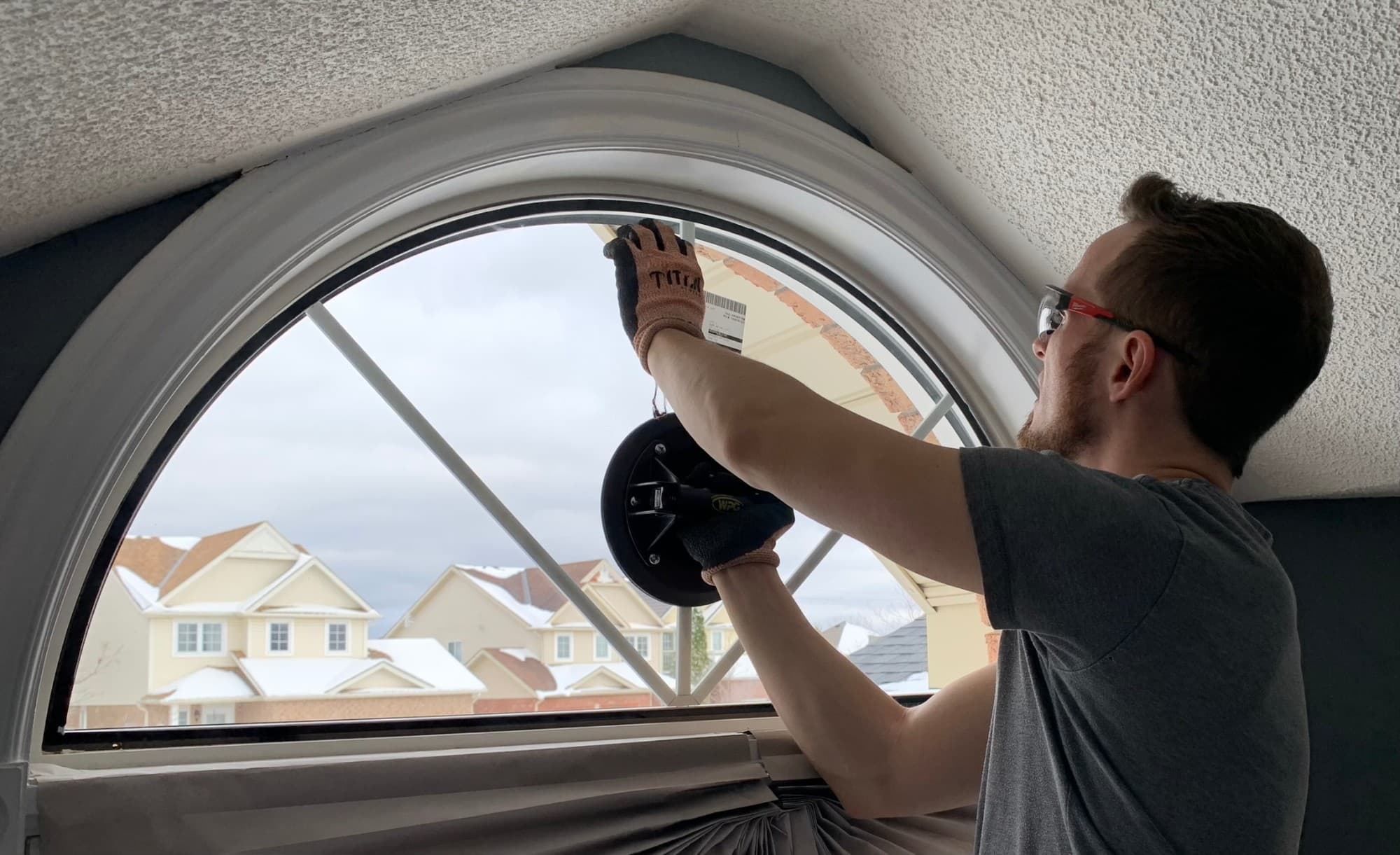 Brett from Window Whiz fitting a new arched sealed unit into the existing window frame