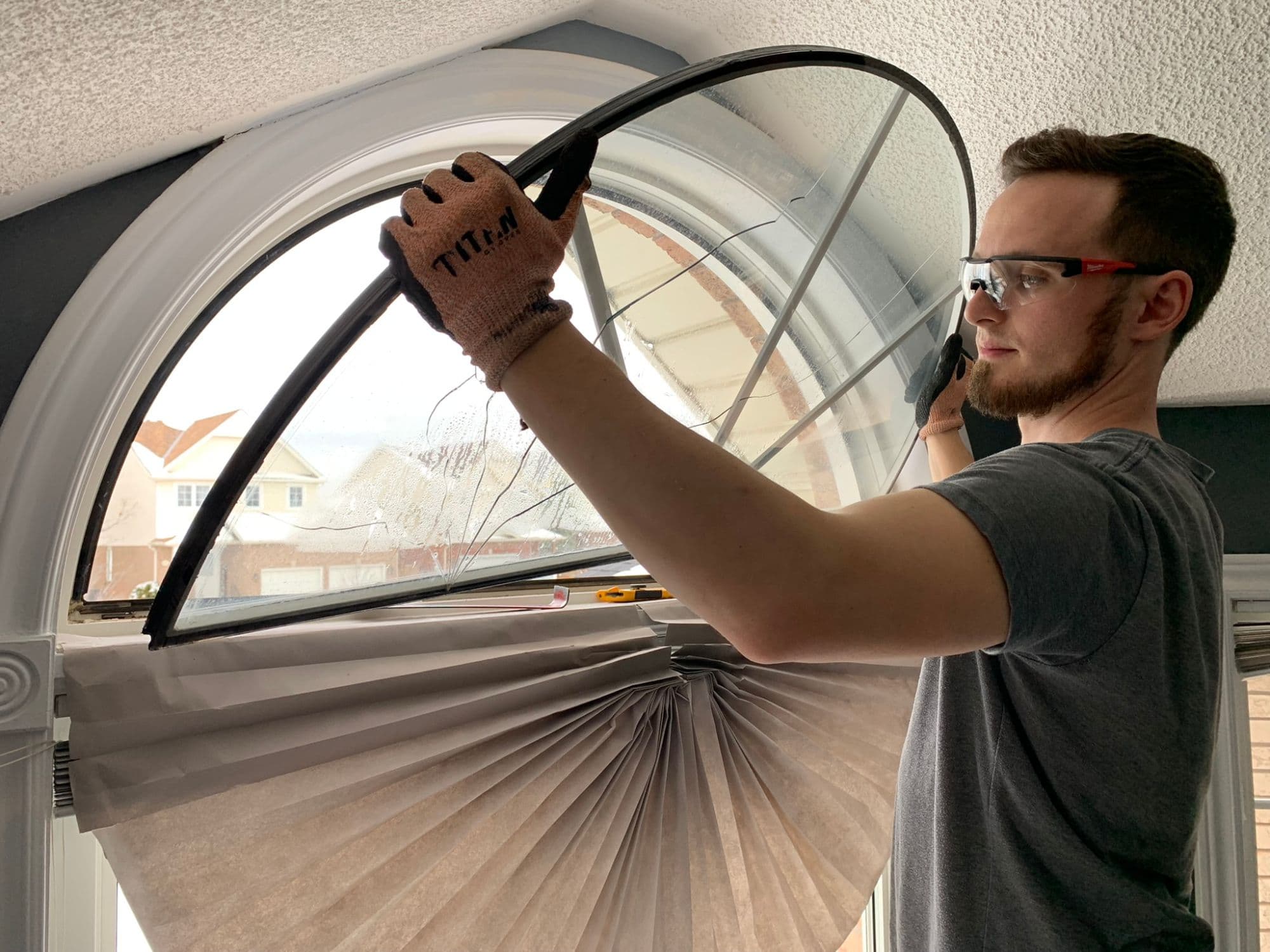Brett from Window Whiz removing a cracked arched sealed unit